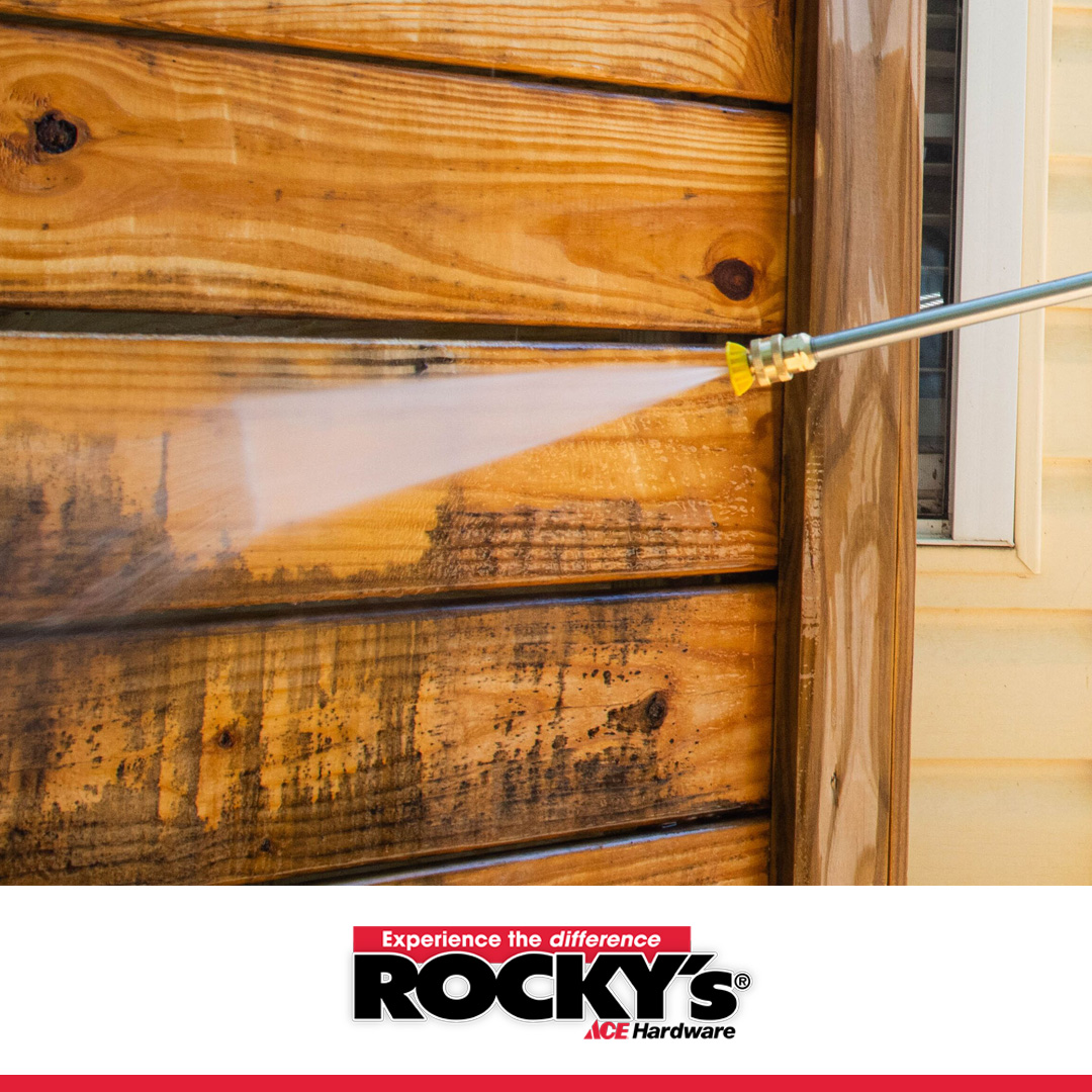 nozzle pressure washing a wooden fence