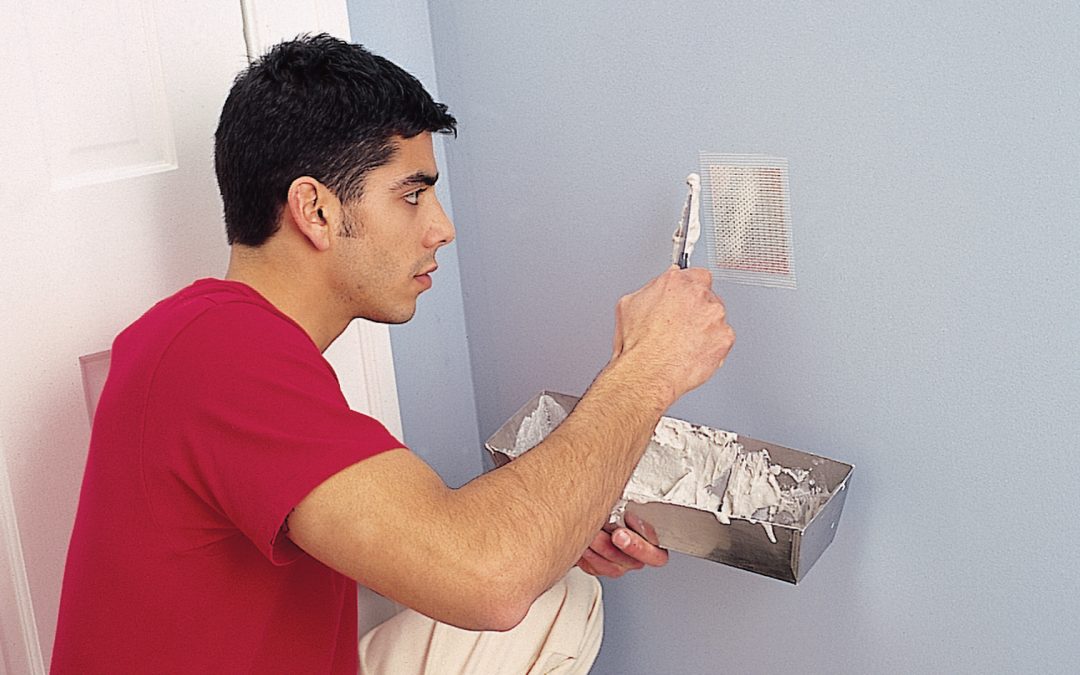 person painting a wall