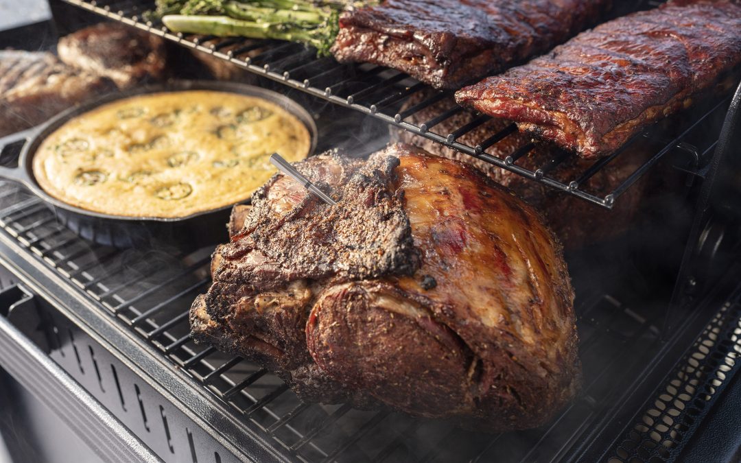 various meats and dishes on a grill