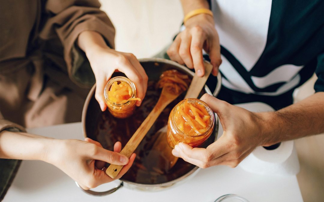 two people canning jam