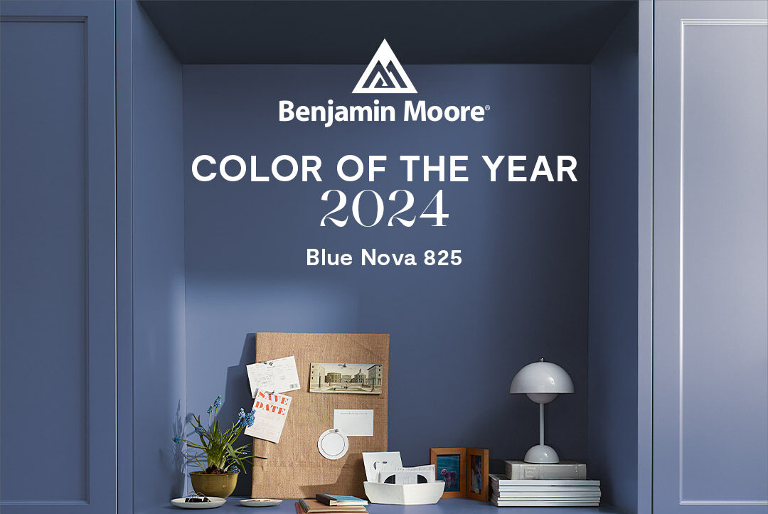 Woman looks at blue paint sample on wall. a Benjamin Moore can sits on a ladder.