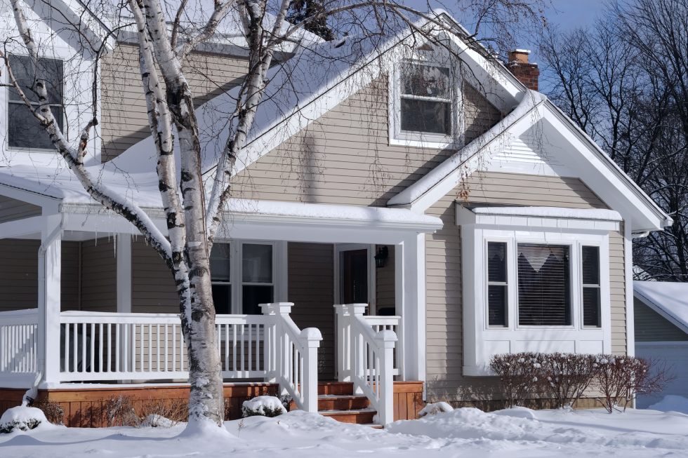 Front of a house with snow on the lawn