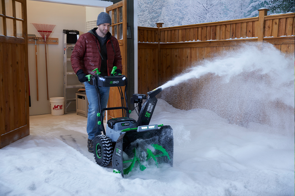 Person using an EGO snow blower to clear their driveway
