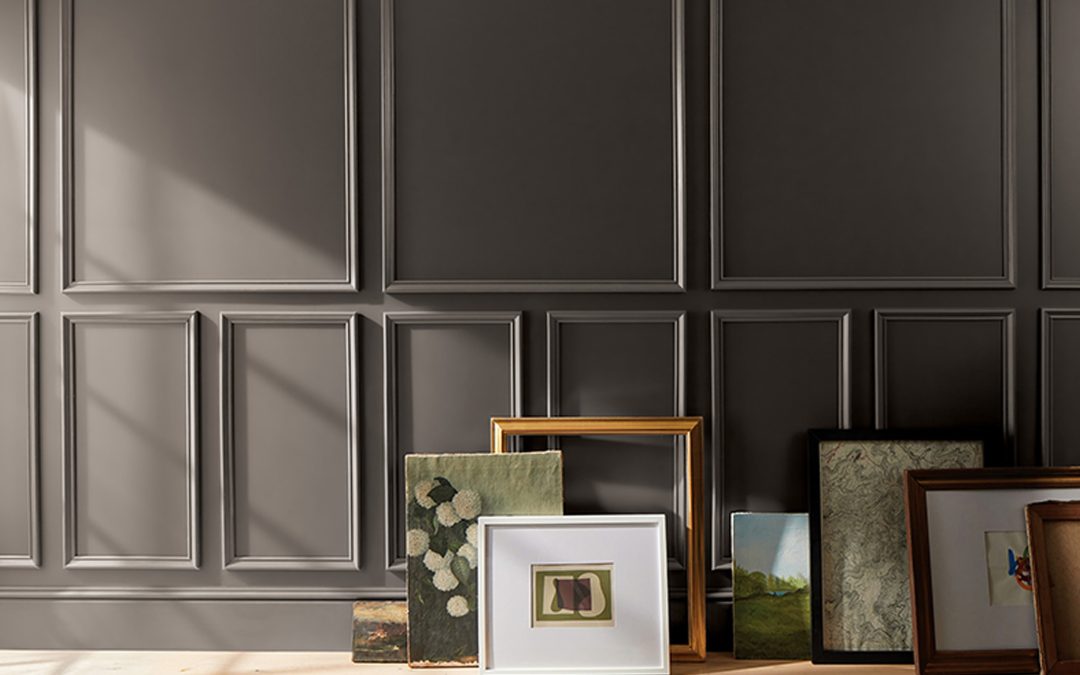 Artwork leaning against a wall painted with Benjamin Moore’s 2026 Color of the Year, Silhouette AF-655