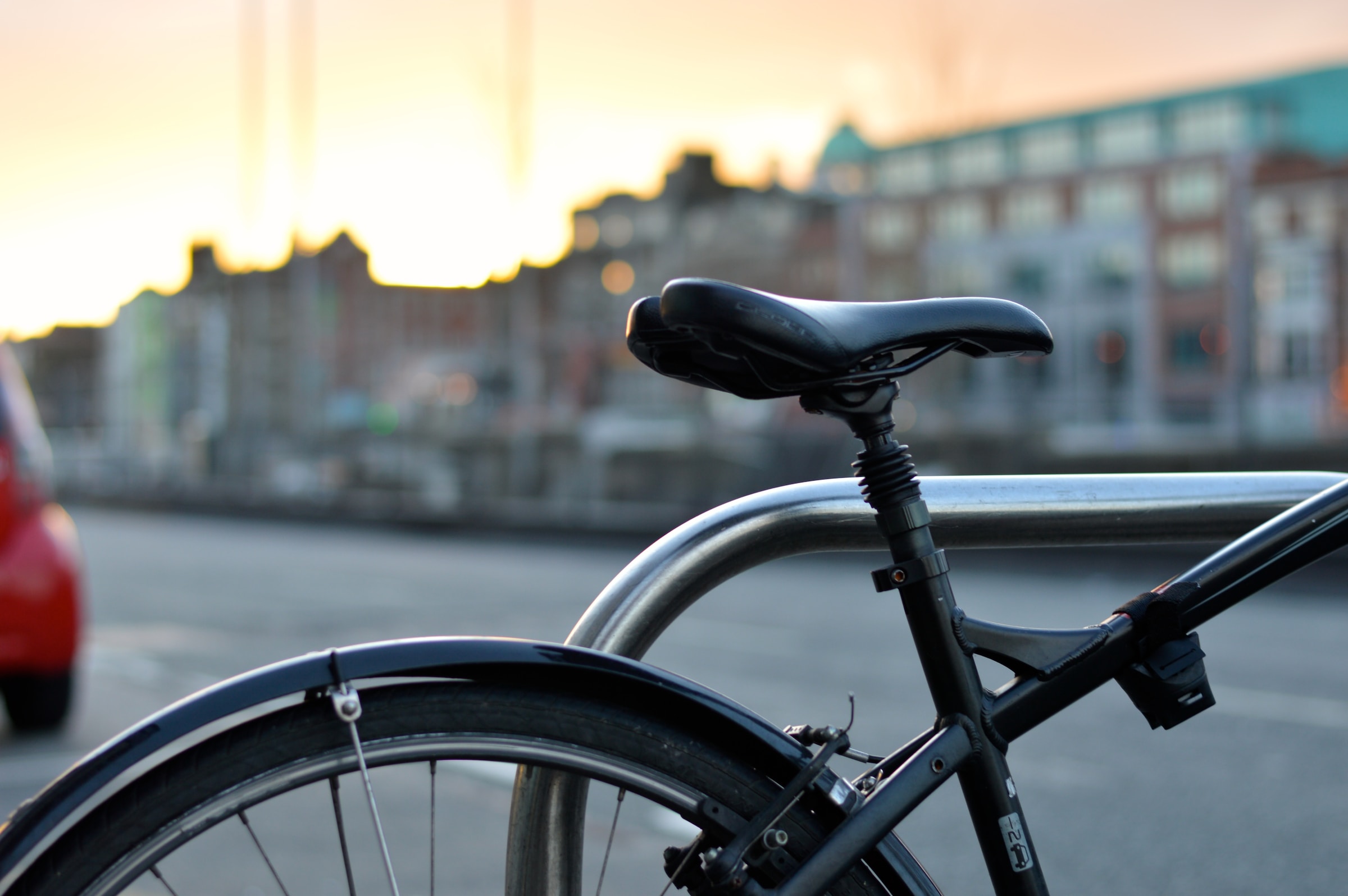 Photo by Alejandro Lopez on Unsplash of the back half of a bicycle at sunset